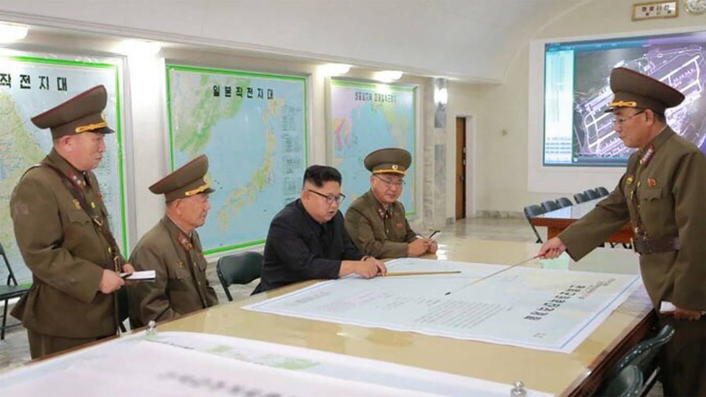 North Korea released photo of Kim Jong Un pouring over targeting maps with his generals, with Andersen AFB—America's sprawling master air base on Guam—projected on a large screen nearby.