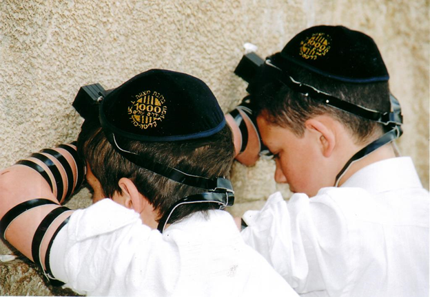 children celebrating a Bar Mitzvah at the Western Wall (Kotel) - photo source colelchabad.org