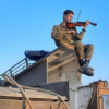 Israel-Hamas Swords of Iron War / Israeli soldier play violin e